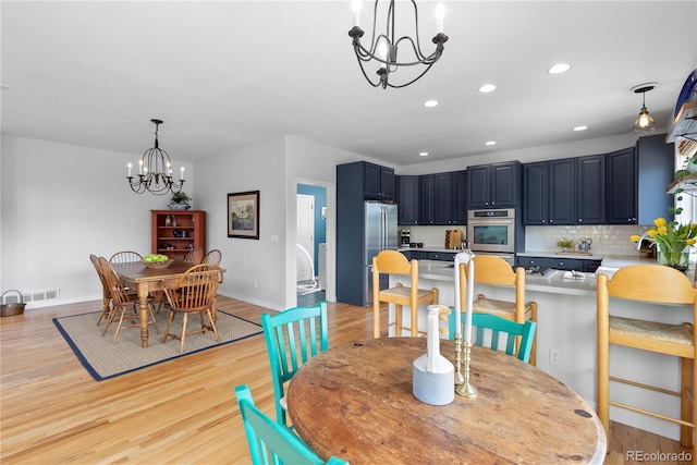 dining room with baseboards, visible vents, light wood-type flooring, a chandelier, and recessed lighting