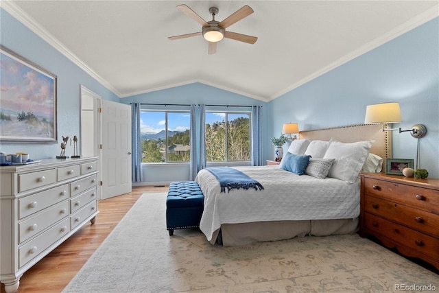 bedroom with lofted ceiling, ceiling fan, ornamental molding, and light wood-style floors