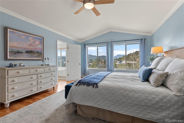 bedroom with vaulted ceiling, multiple windows, wood finished floors, and crown molding