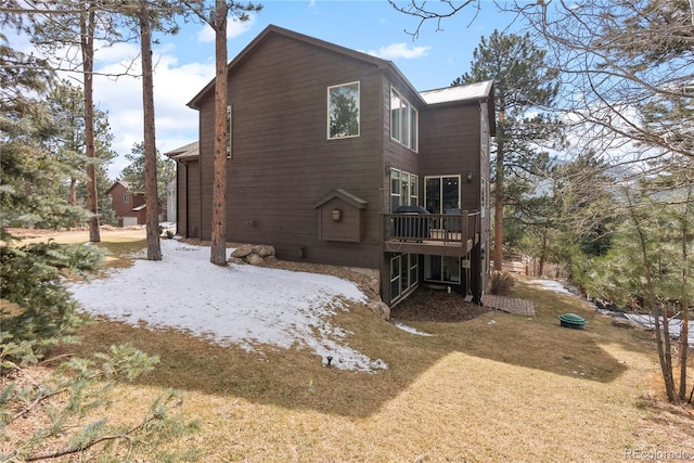 view of home's exterior with a lawn and a wooden deck