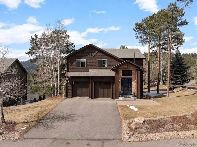 view of front of property featuring a shingled roof, driveway, and an attached garage