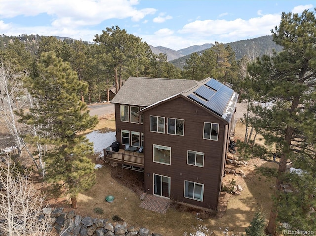 exterior space featuring a forest view and a mountain view