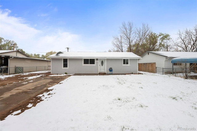 snow covered property featuring fence