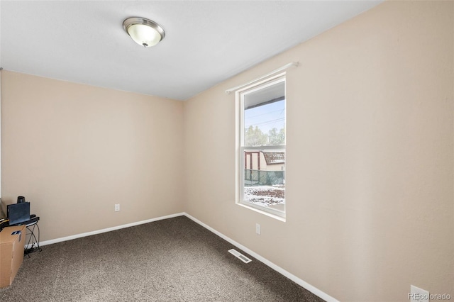 spare room featuring baseboards, carpet, and visible vents