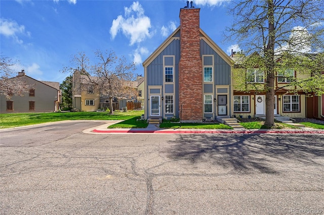 view of front of property with board and batten siding and a chimney