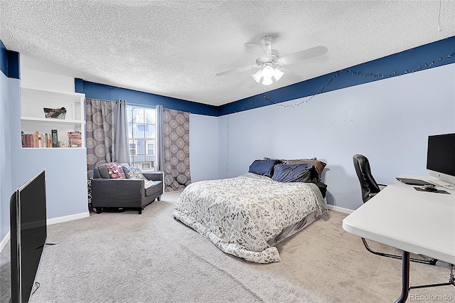 bedroom with carpet flooring, a textured ceiling, ceiling fan, and baseboards
