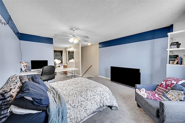 carpeted bedroom featuring a ceiling fan, a textured ceiling, and attic access
