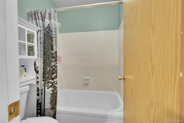 bathroom featuring shower / bath combo with shower curtain and toilet