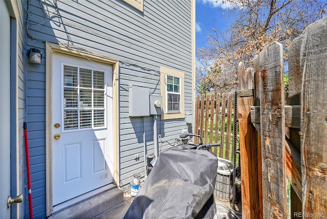 doorway to property featuring fence