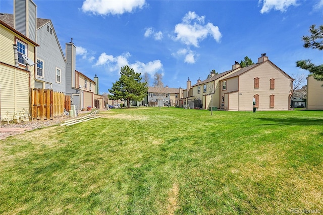 view of yard featuring fence and a residential view