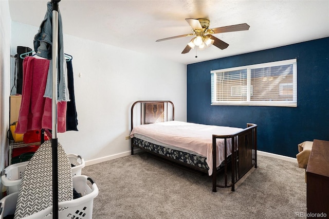 carpeted bedroom featuring ceiling fan and baseboards