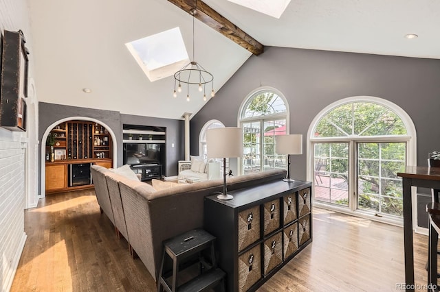 1000 N Monaco Pkwy, Denver, CO 80220 - living room featuring a skylight, wood finished floors, beam ceiling, built in features, and beverage cooler