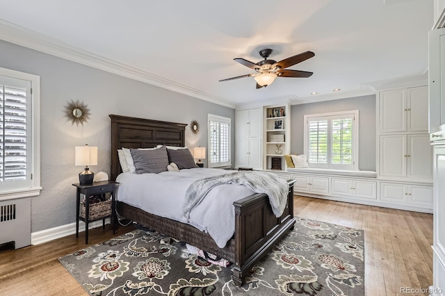 1000 N Monaco Pkwy, Denver, CO 80220 - bedroom with radiator heating unit, light wood-style flooring, ornamental molding, baseboards, and a ceiling fan