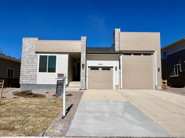 view of front facade with driveway and an attached garage