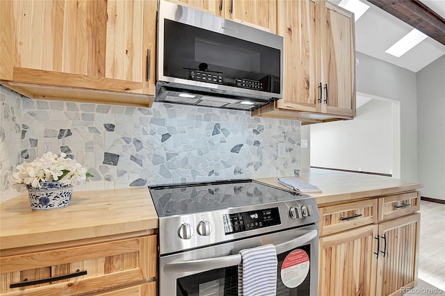 kitchen with backsplash, a skylight, light brown cabinetry, appliances with stainless steel finishes, and light hardwood / wood-style floors