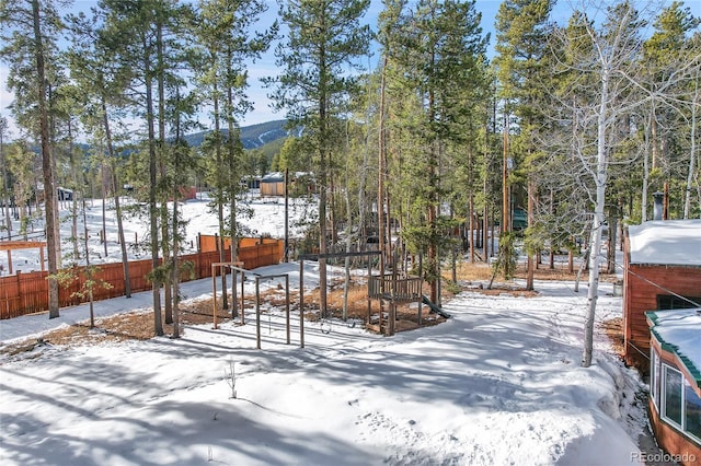 snowy yard with a mountain view