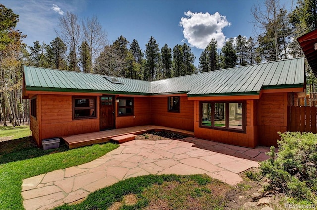 9123 Booker Ln, Conifer, CO 80433 - back of property with a patio and metal roof