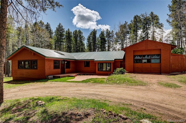 9123 Booker Ln, Conifer, CO 80433 - ranch-style home with metal roof and dirt driveway