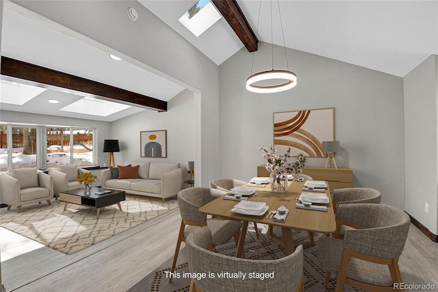9123 Booker Ln, Conifer, CO 80433 - dining space featuring recessed lighting, baseboards, wood finished floors, and vaulted ceiling with skylight