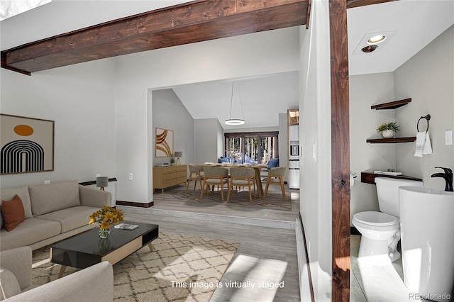 9123 Booker Ln, Conifer, CO 80433 - living room featuring baseboards, vaulted ceiling, and wood finished floors