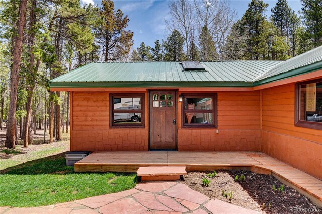 9123 Booker Ln, Conifer, CO 80433 - property entrance with a metal roof