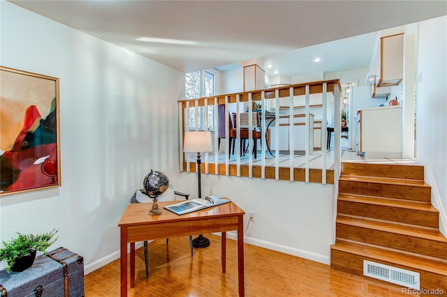 stairway with hardwood / wood-style floors