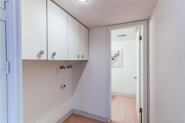 laundry room with light tile patterned floors, hookup for a washing machine, cabinets, and hookup for an electric dryer