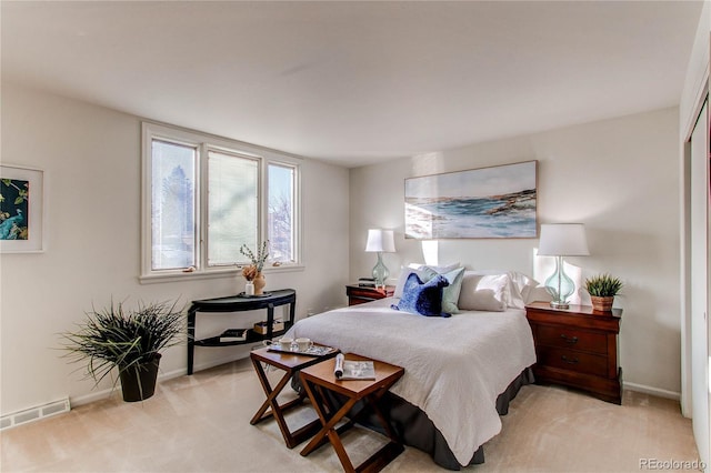 bedroom featuring light colored carpet