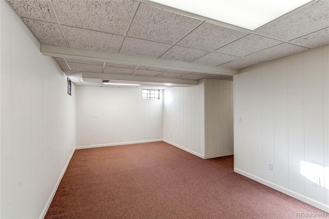 basement featuring carpet and a drop ceiling