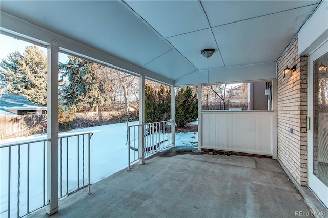 unfurnished sunroom with lofted ceiling