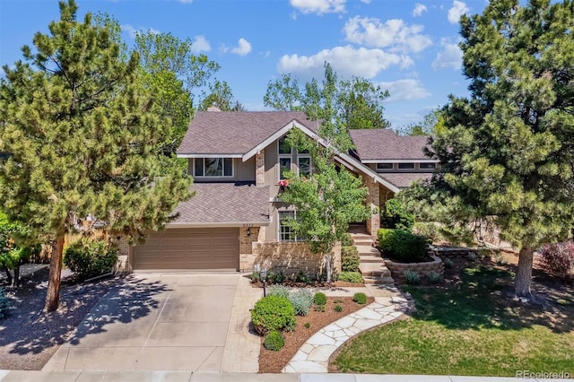 5373 E Links Cir, Centennial, CO 80122 - view of front facade with concrete driveway, brick siding, a garage, a shingled roof, and a front yard