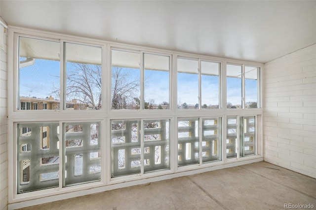 unfurnished sunroom with lofted ceiling