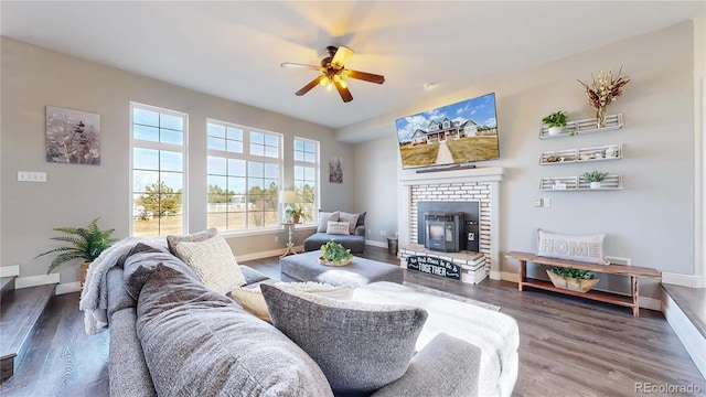 living area featuring ceiling fan, baseboards, and wood finished floors