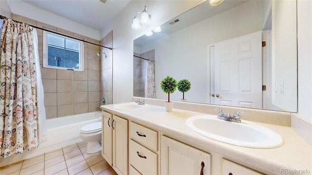 bathroom featuring tile patterned floors, a sink, visible vents, and shower / bathtub combination with curtain