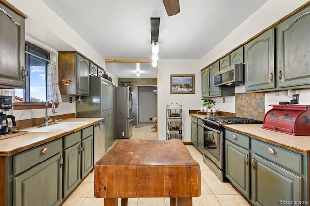 kitchen with ceiling fan, light tile patterned floors, sink, and appliances with stainless steel finishes