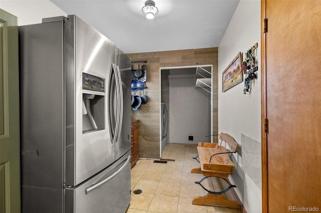 interior space with wood walls and light tile patterned flooring