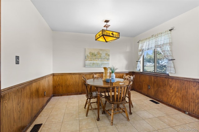 tiled dining space with wood walls