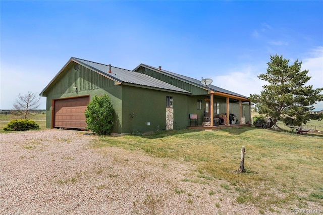 view of property exterior featuring a yard and a garage