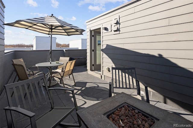 view of patio featuring a fire pit and outdoor dining area