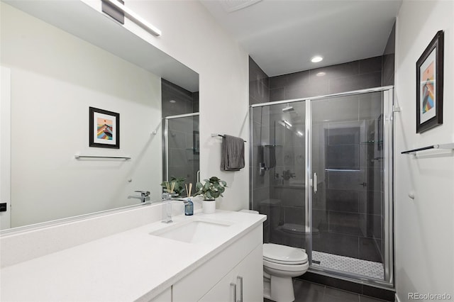 bathroom with toilet, a stall shower, recessed lighting, and vanity