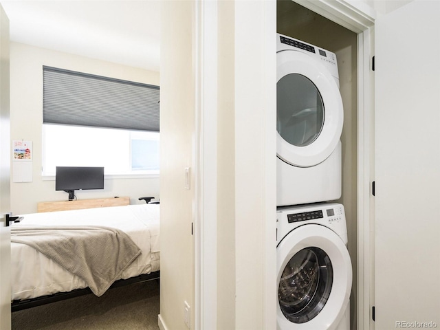 clothes washing area with stacked washer / drying machine and laundry area