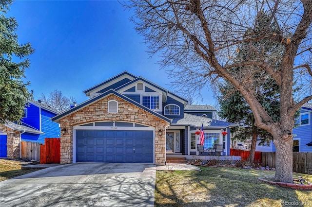 view of front of home featuring a front yard, concrete driveway, a garage, and fence