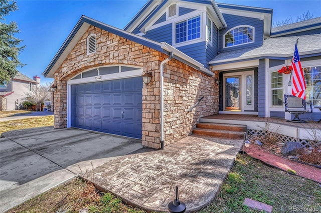 view of front of house featuring stone siding, an attached garage, concrete driveway, and a shingled roof