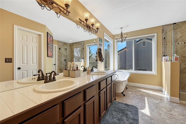 full bath with a sink, a chandelier, and a shower stall