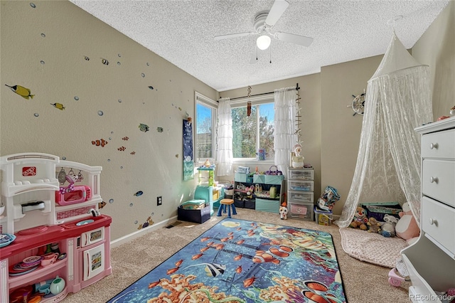 game room with baseboards, a textured ceiling, carpet, and a ceiling fan