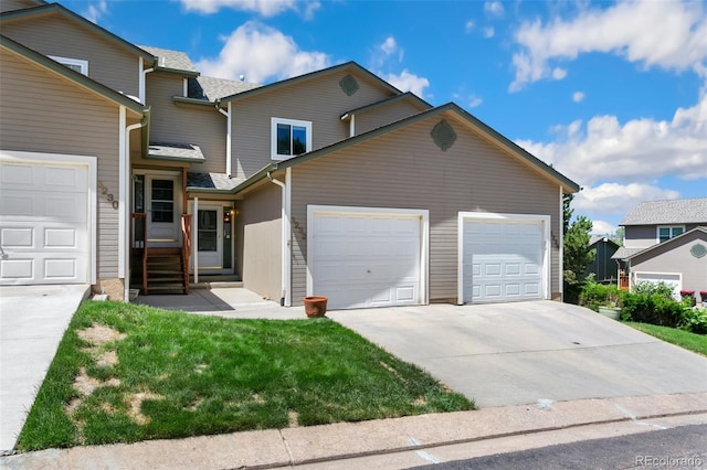 front of property featuring a front yard and a garage