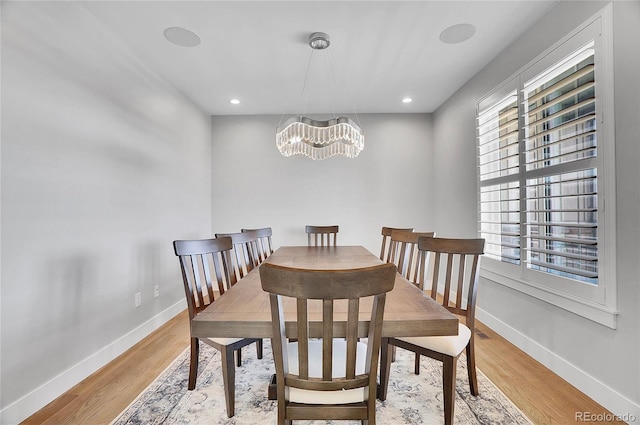 dining space featuring a chandelier and light wood-type flooring