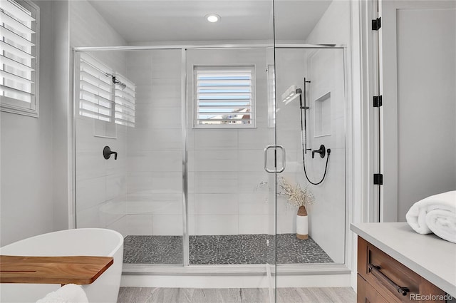 bathroom featuring vanity and separate shower and tub