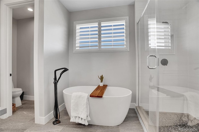 bathroom featuring a healthy amount of sunlight and plus walk in shower