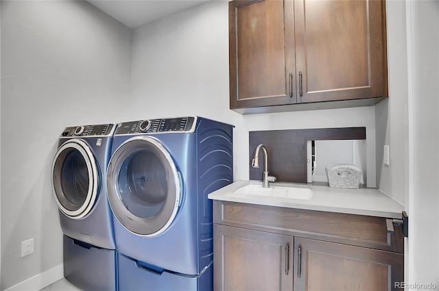 laundry area with cabinets, sink, and washer and dryer